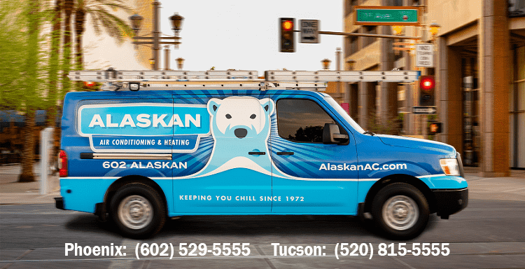 Alaskan branded van on street with contact phone numbers underneath