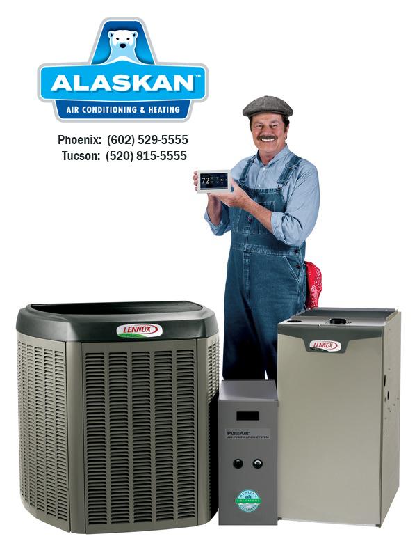 Happy technician standing behind Lennox equipment holding a thermostat with Alaskan Air Conditioning and Heating logo and contact phone numbers in upper left corner