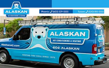 Alaskan branded van with ladder on rack on top outside