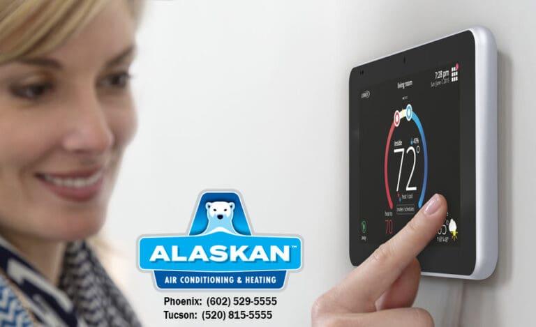 Woman smiling while adjusting digital thermostat, Alaskan Air Conditioning and Heating logo and contact phone numbers in bottom middle section of image